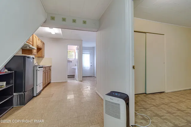 a view of a room with a wooden floor and a window