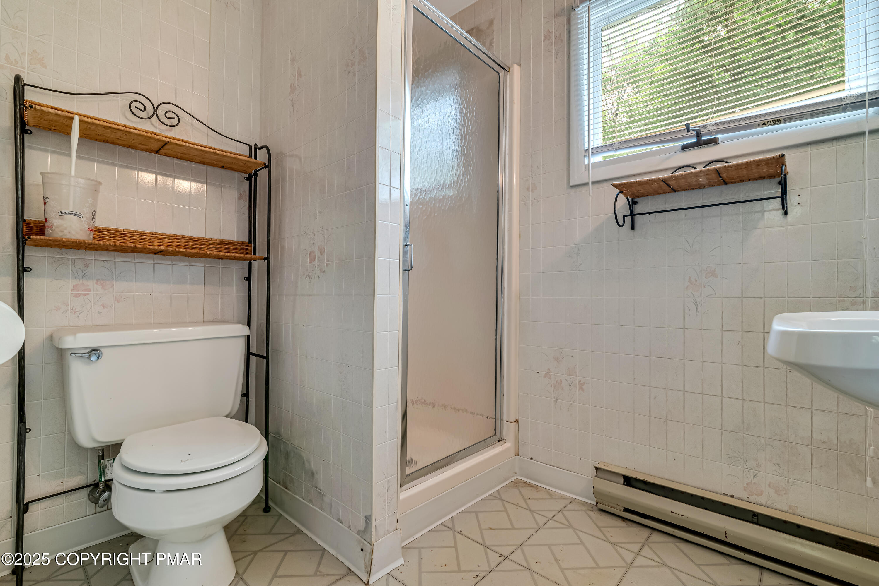 129 Winona Road Mount Pocono, PA 18344 - Photo 45 of 64 a bathroom with a toilet a sink and shower