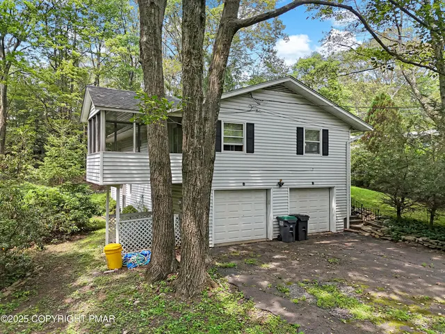 a view of a house with a backyard and a patio