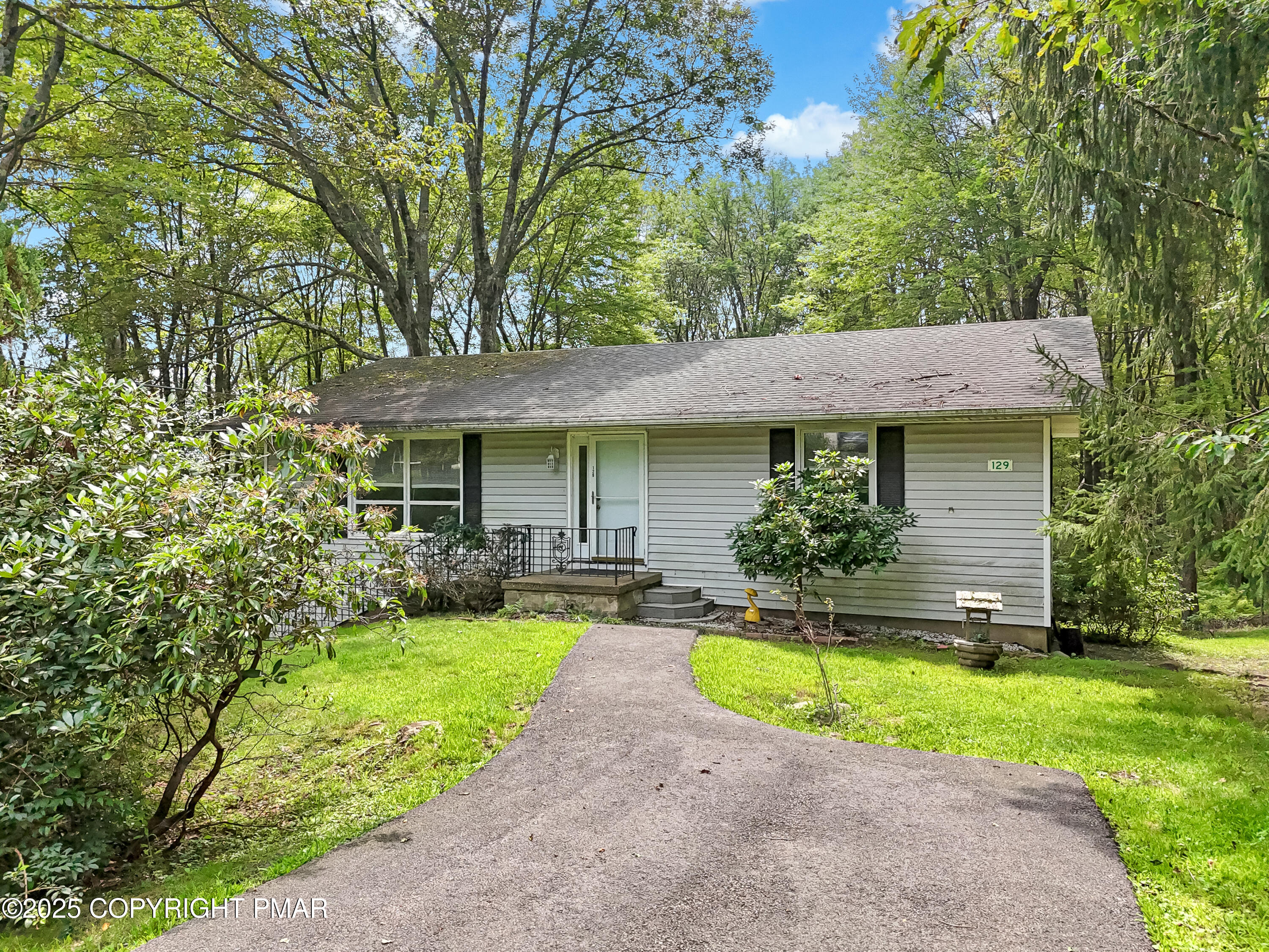 129 Winona Road Mount Pocono, PA 18344 - Photo 64 of 64 a front view of a house with a yard and porch