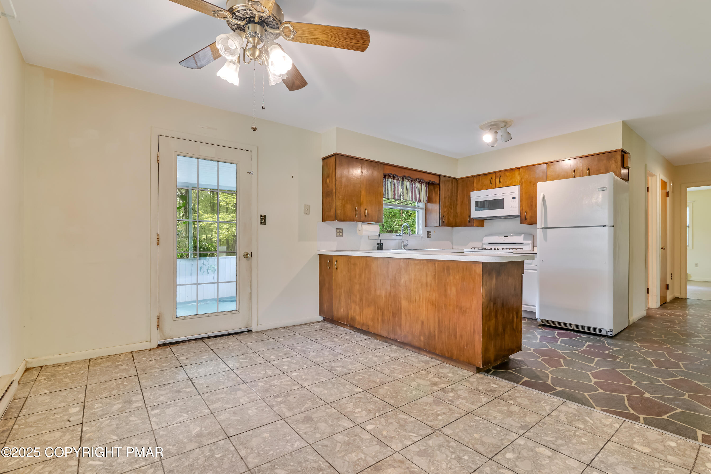 129 Winona Road Mount Pocono, PA 18344 - Photo 7 of 64 a kitchen with stainless steel appliances a refrigerator sink and cabinets