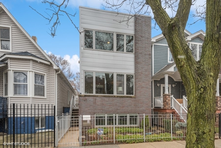 1745 North Troy Street Chicago, IL 60647 - Photo 1 of 29 a front view of a house with a garden