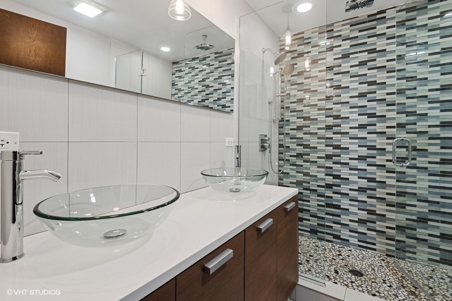 1745 North Troy Street Chicago, IL 60647 - Photo 11 of 29 a bathroom with a sink a toilet and shower