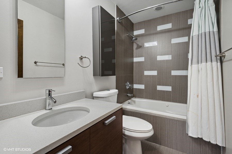 1745 North Troy Street Chicago, IL 60647 - Photo 14 of 29 a bathroom with a sink a toilet and shower