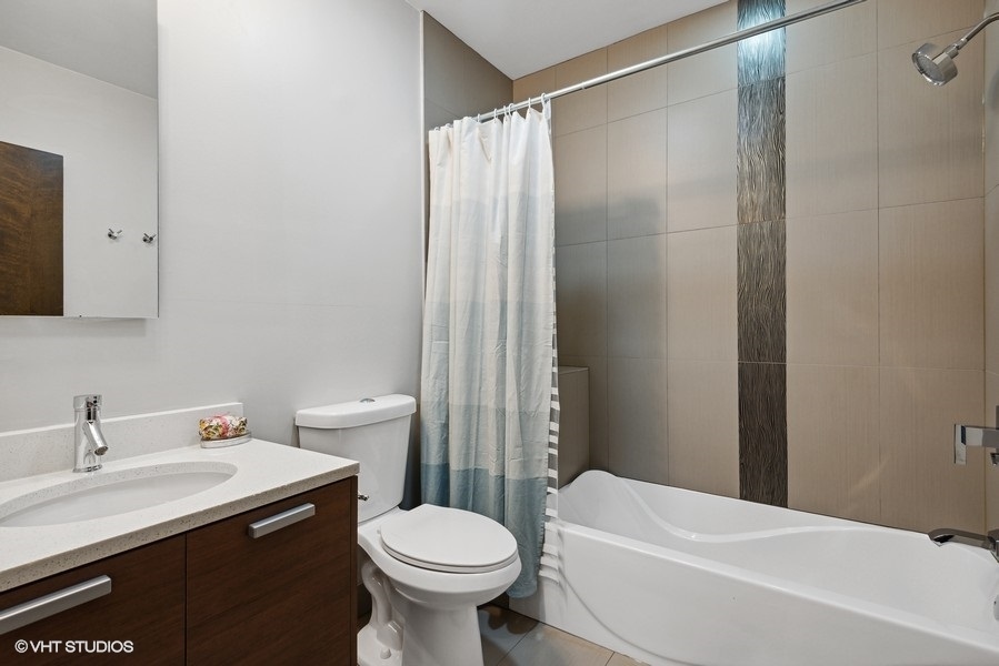 1745 North Troy Street Chicago, IL 60647 - Photo 15 of 29 a bathroom with a sink toilet and shower