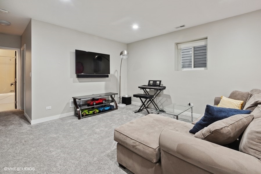 1745 North Troy Street Chicago, IL 60647 - Photo 19 of 29 a living room with furniture and a flat screen tv