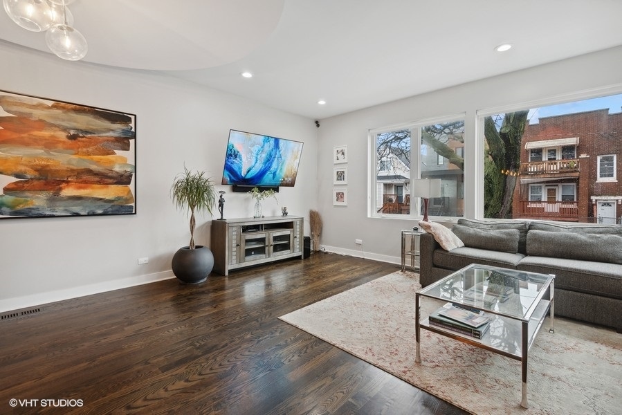 1745 North Troy Street Chicago, IL 60647 - Photo 3 of 29 a living room with furniture and a flat screen tv