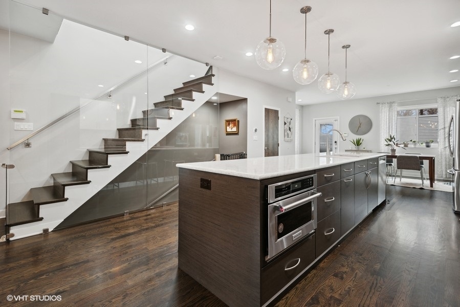 1745 North Troy Street Chicago, IL 60647 - Photo 6 of 29 a kitchen with a stove and a wooden floor