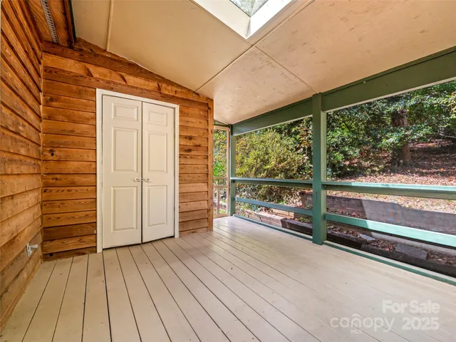 a view of a porch with wooden floor and iron stairs