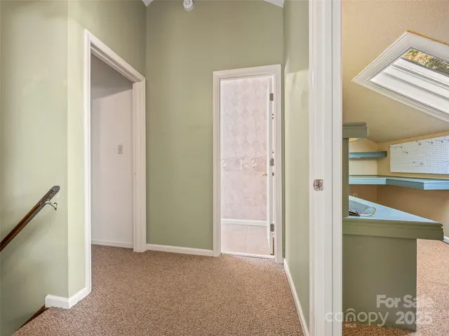 a view of a hallway with a bathroom