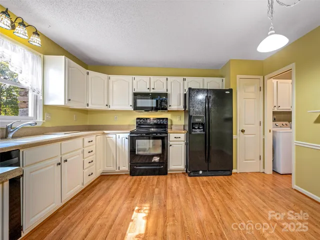 a kitchen with a refrigerator and a stove top oven