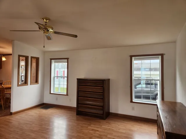 a view of a livingroom with furniture and a ceiling fan