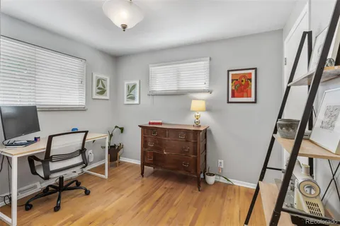 a view of a workspace with furniture and a window