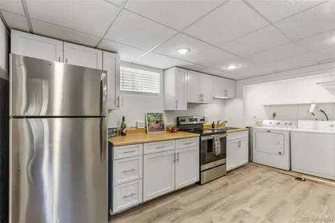 a kitchen with a refrigerator sink and cabinets