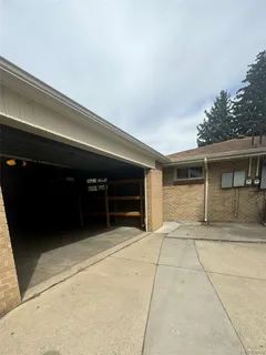 a view of room that has a chair and a ceiling fan
