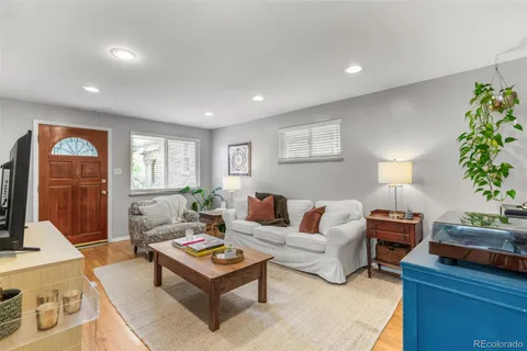 a living room with furniture and a lamp