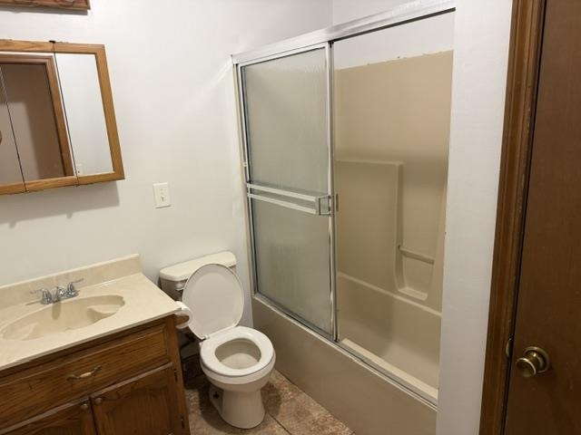 9450 Holly Grove Road Brighton, TN 38011 - Photo 3 of 10 Full bathroom featuring a wood-finish vanity with an integrated sink, a commode, and a tub/shower combination with sliding frosted glass doors