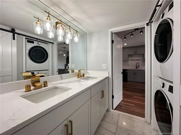 a bathroom with a sink a washer and dryer