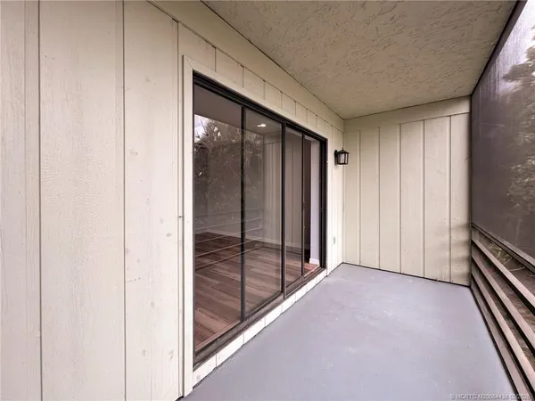 a view of a glass door and deck