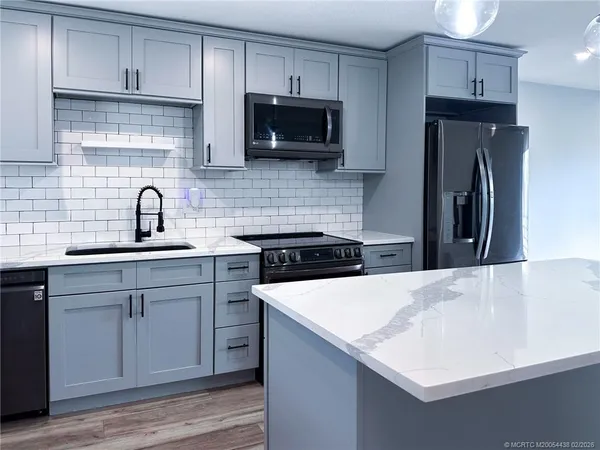 a kitchen with a sink a stove and refrigerator