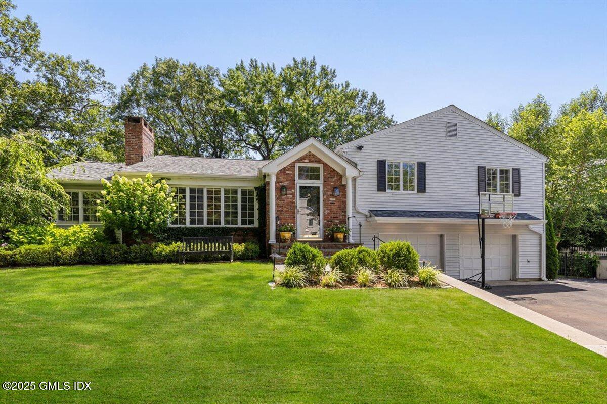 44 Bote Road Greenwich, CT 06830 - Photo 1 of 30 a front view of house with yard and green space
