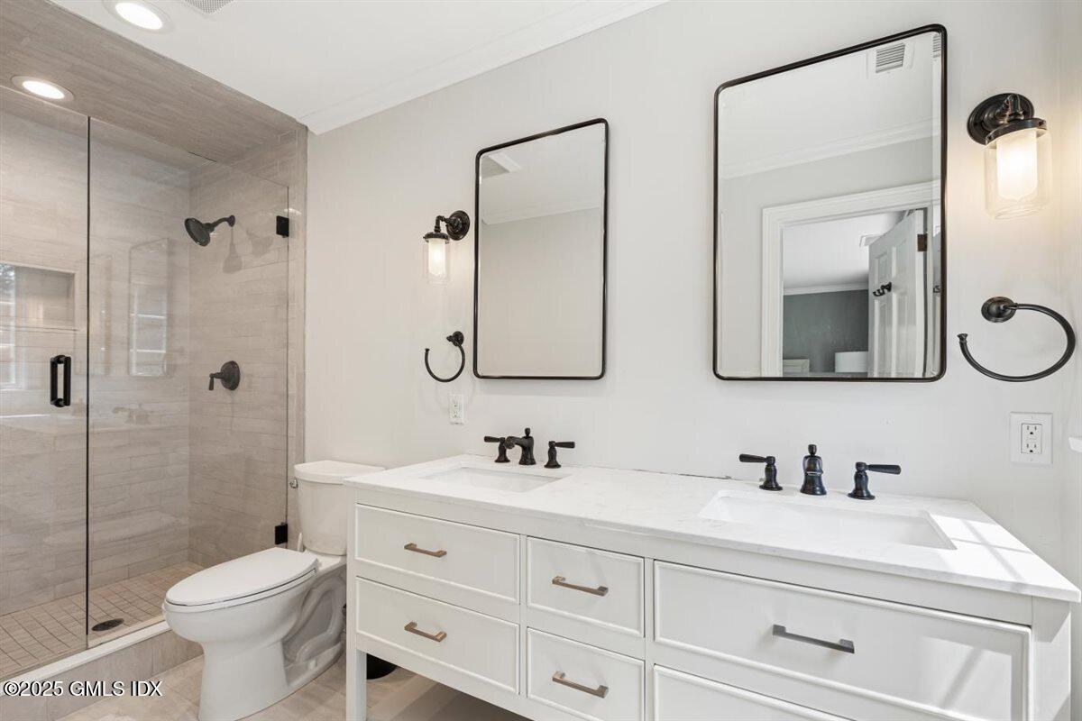 44 Bote Road Greenwich, CT 06830 - Photo 15 of 30 a bathroom with a toilet sink double vanity and mirror
