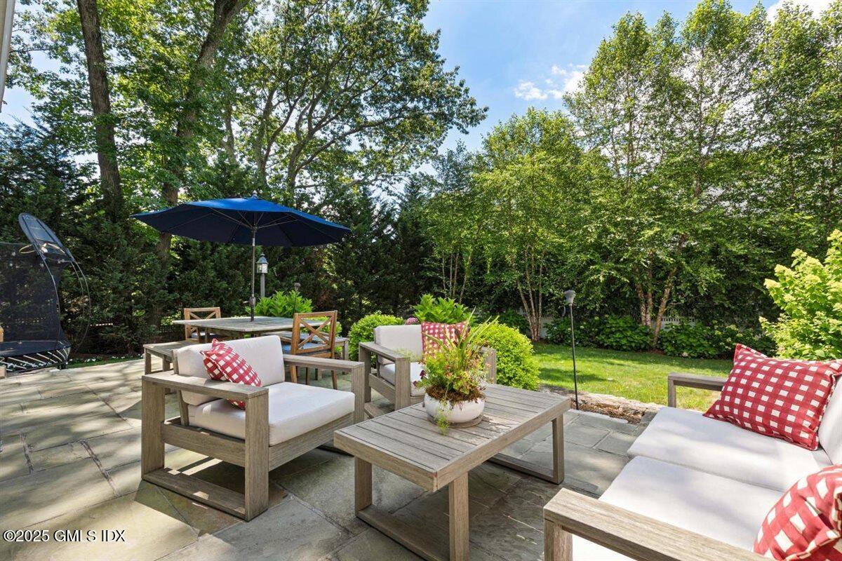 44 Bote Road Greenwich, CT 06830 - Photo 19 of 30 an outdoor sitting area with furniture and a garden