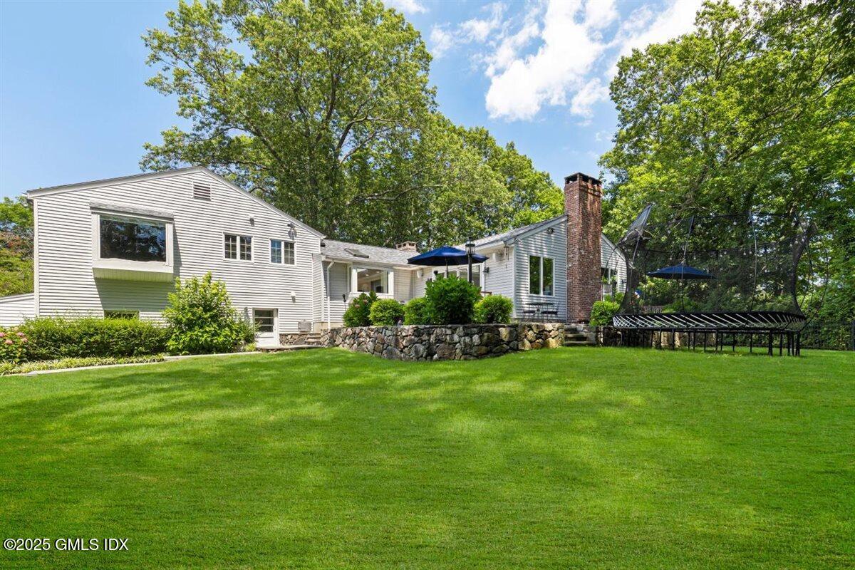 44 Bote Road Greenwich, CT 06830 - Photo 22 of 30 a front view of house with yard and green space
