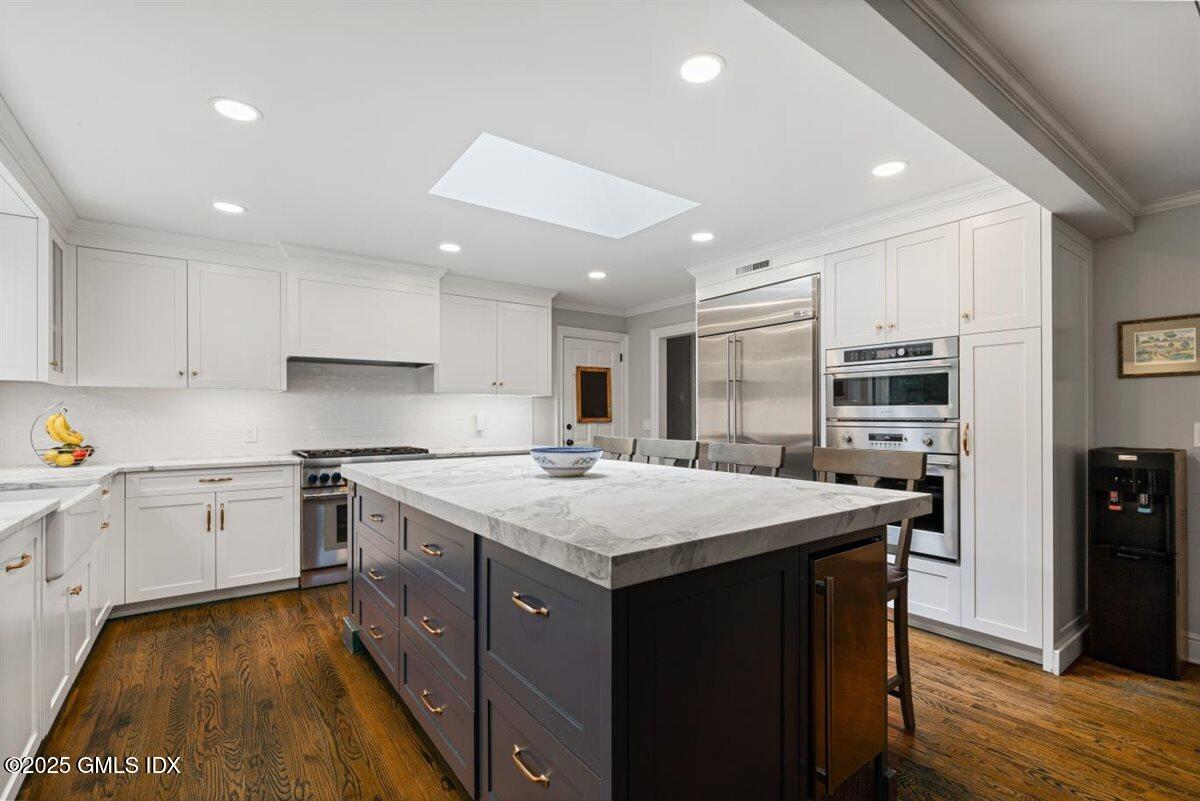 44 Bote Road Greenwich, CT 06830 - Photo 6 of 30 a kitchen with a stove sink and cabinets