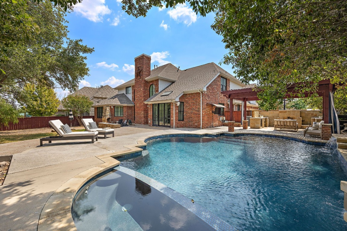a swimming pool view with a outdoor seating