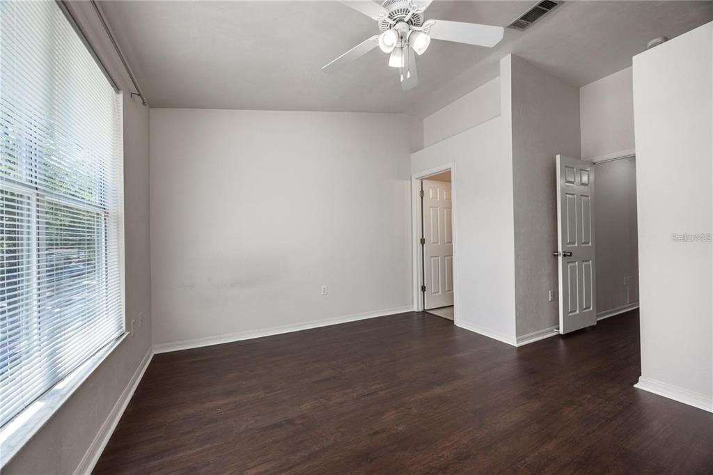 3510 Southwest 30th Way, Unit 158 Gainesville, FL 32608 - Photo 25 of 27 a view of an empty room with wooden floor and a window