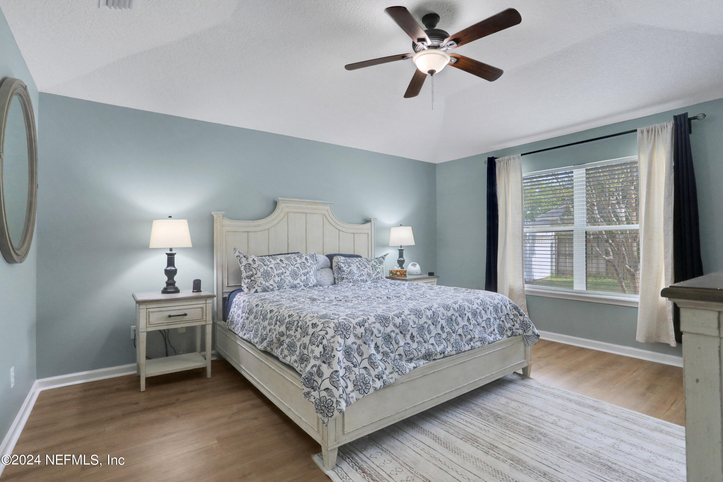 2000 Spring Meadows Court St. Augustine, FL 32092 - Photo 23 of 40 a bedroom with a bed chandelier and a window