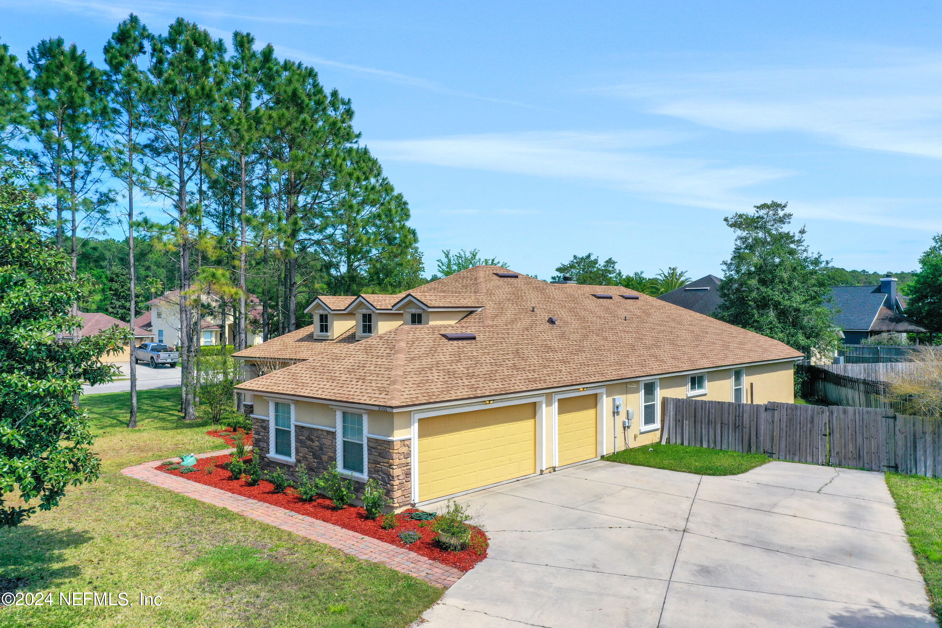 2000 Spring Meadows Court St. Augustine, FL 32092 - Photo 4 of 40 a aerial view of a house with table and chairs under an umbrella