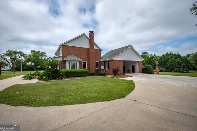 a view of a field of grass and trees
