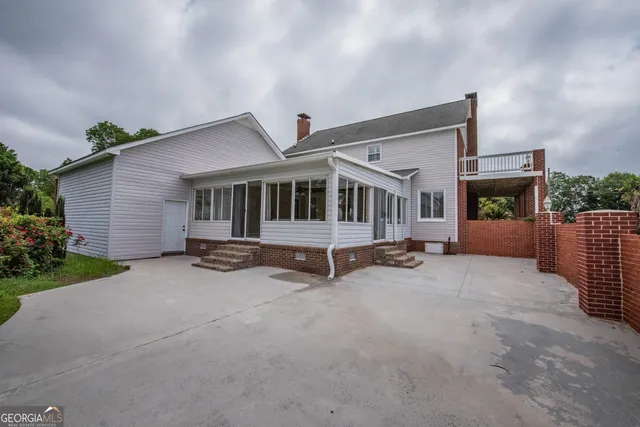 a dining room with furniture a chandelier and wooden floor