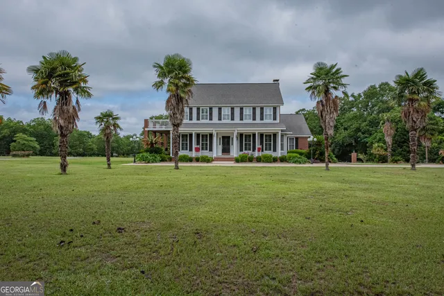 a front view of house with yard and green space