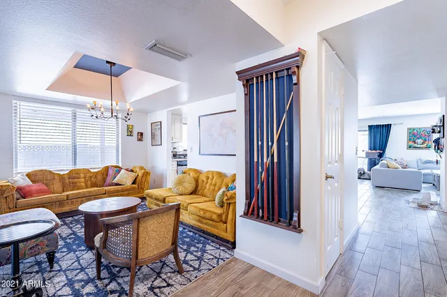 a living room with furniture and paintings on the wall