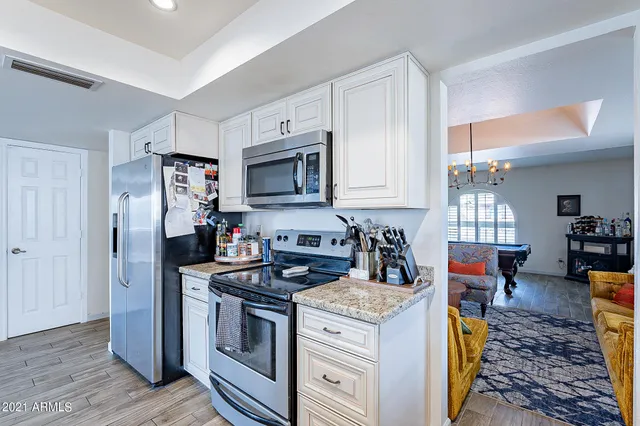 a kitchen with a refrigerator stove and sink