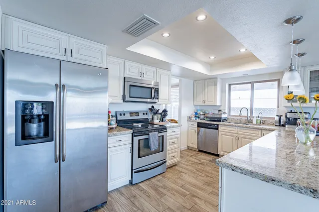 a kitchen with sink cabinets and window
