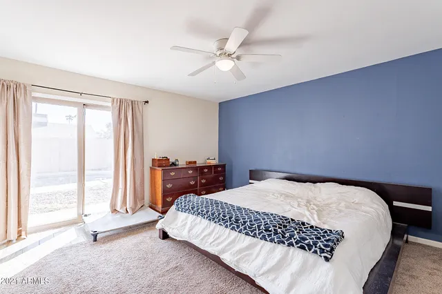 a bedroom with a bed dresser and a window