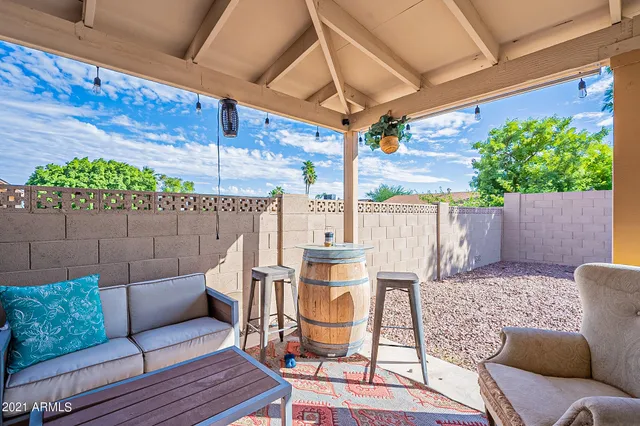 a view of a house with backyard and sitting area