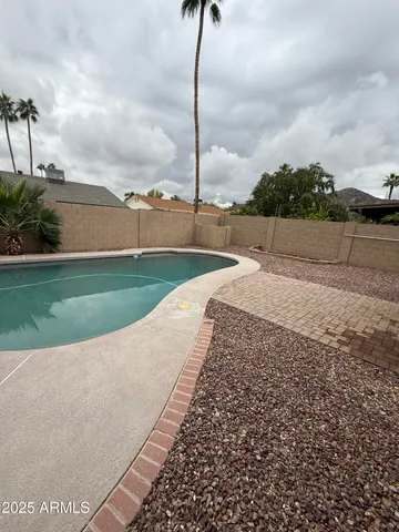 a view of a wooden house with a swimming pool and roof