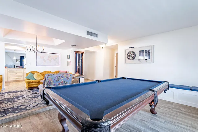 a living room with furniture potted plant and a chandelier