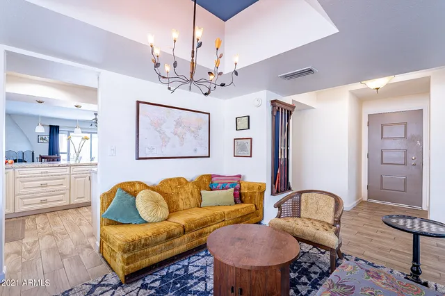 a living room with furniture a rug and wooden floor