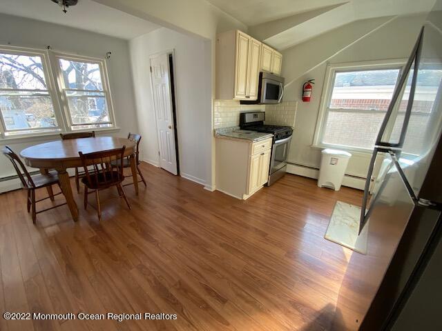 9 Howland Avenue, Unit 2 Long Branch, NJ 07740 - Photo 2 of 8 a view of a dining room with furniture window and wooden floor