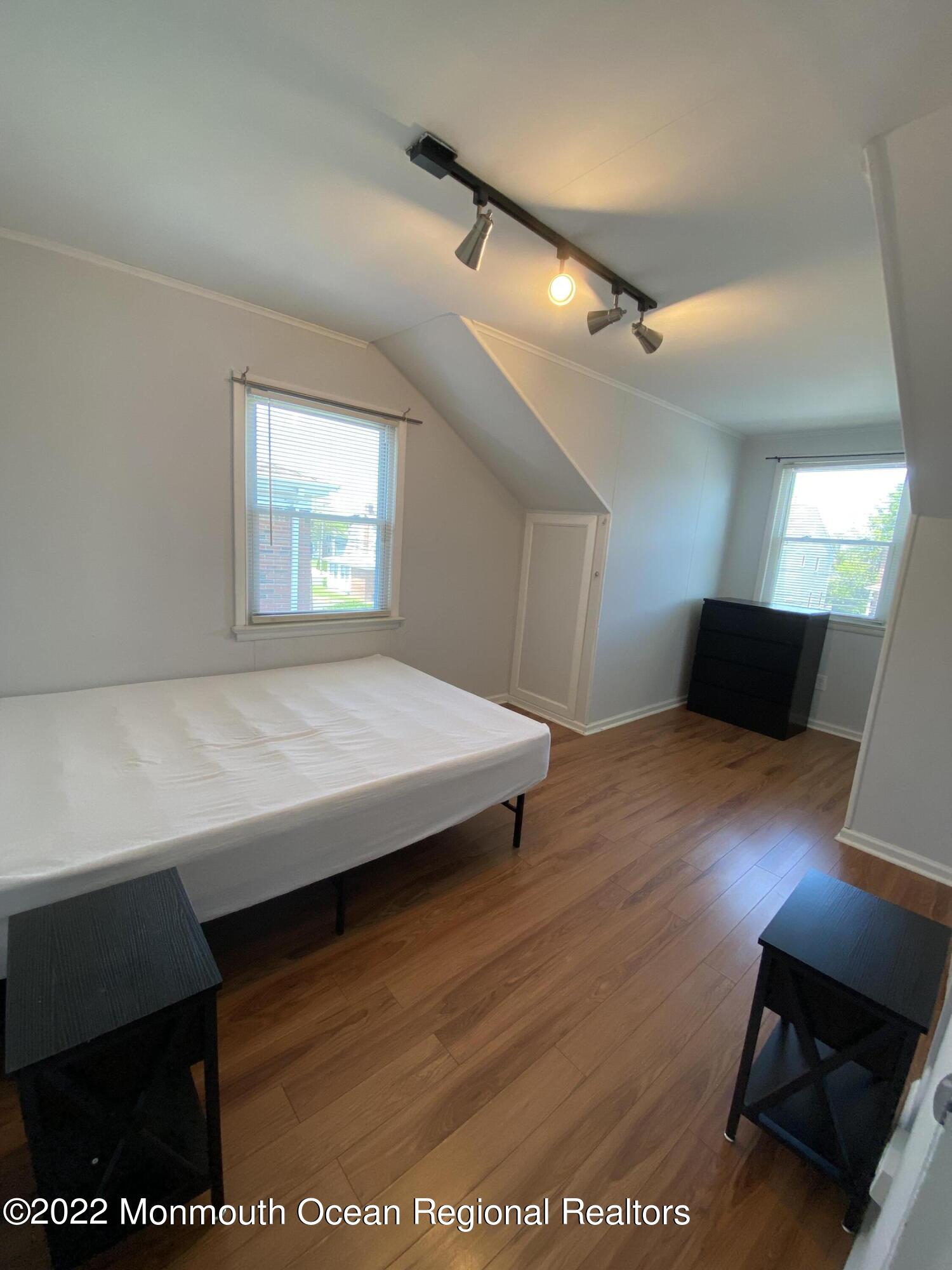 9 Howland Avenue, Unit 2 Long Branch, NJ 07740 - Photo 3 of 8 a view of a room with wooden floor and windows