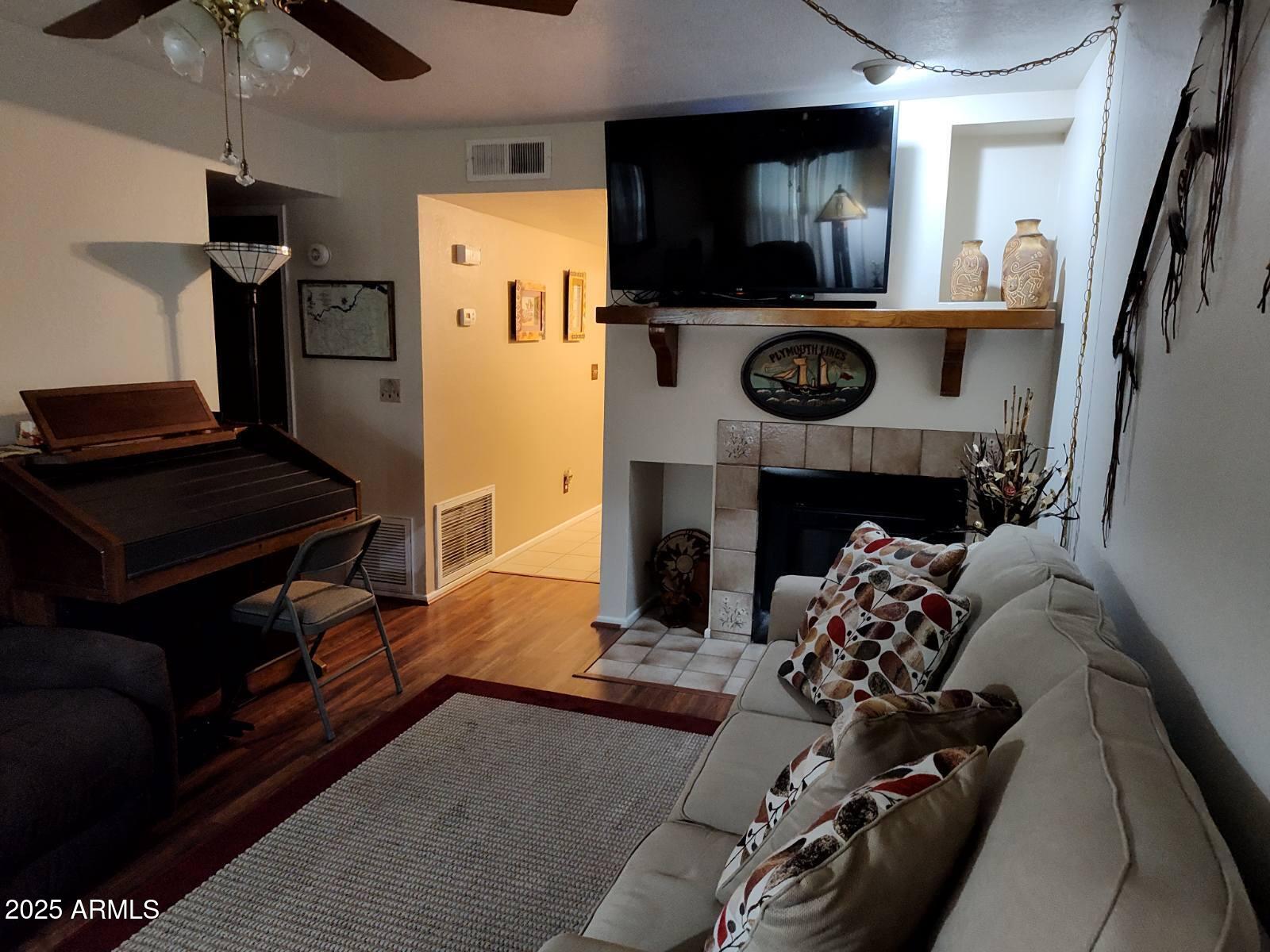 455 North Delaware Drive, Unit 7 Apache Junction, AZ 85120 - Photo 2 of 5 a living room with furniture and a fireplace
