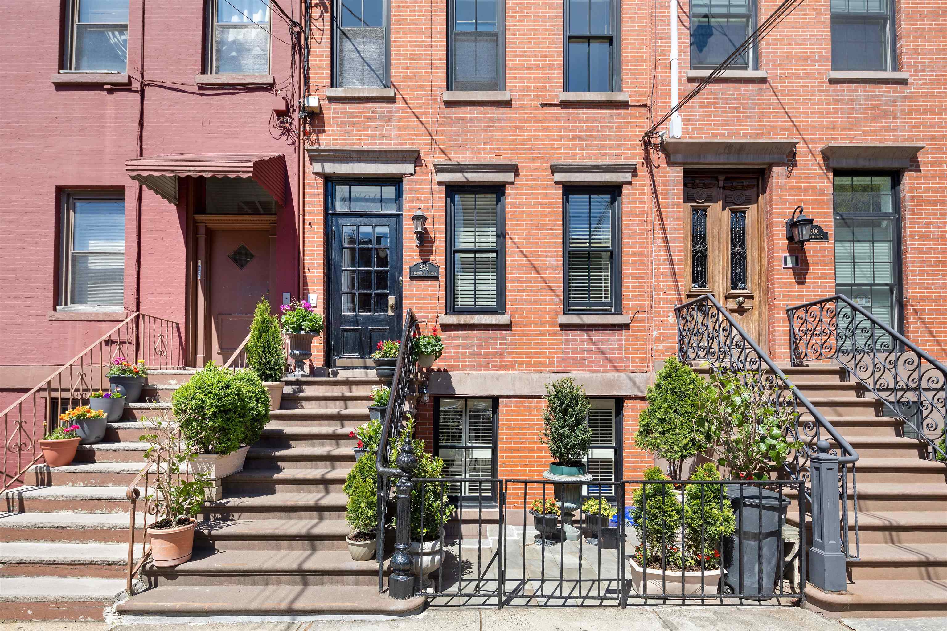 804 Bloomfield Street, Unit 2 Hoboken, NJ 07030 - Photo 13 of 14 front view of a brick house with a small yard