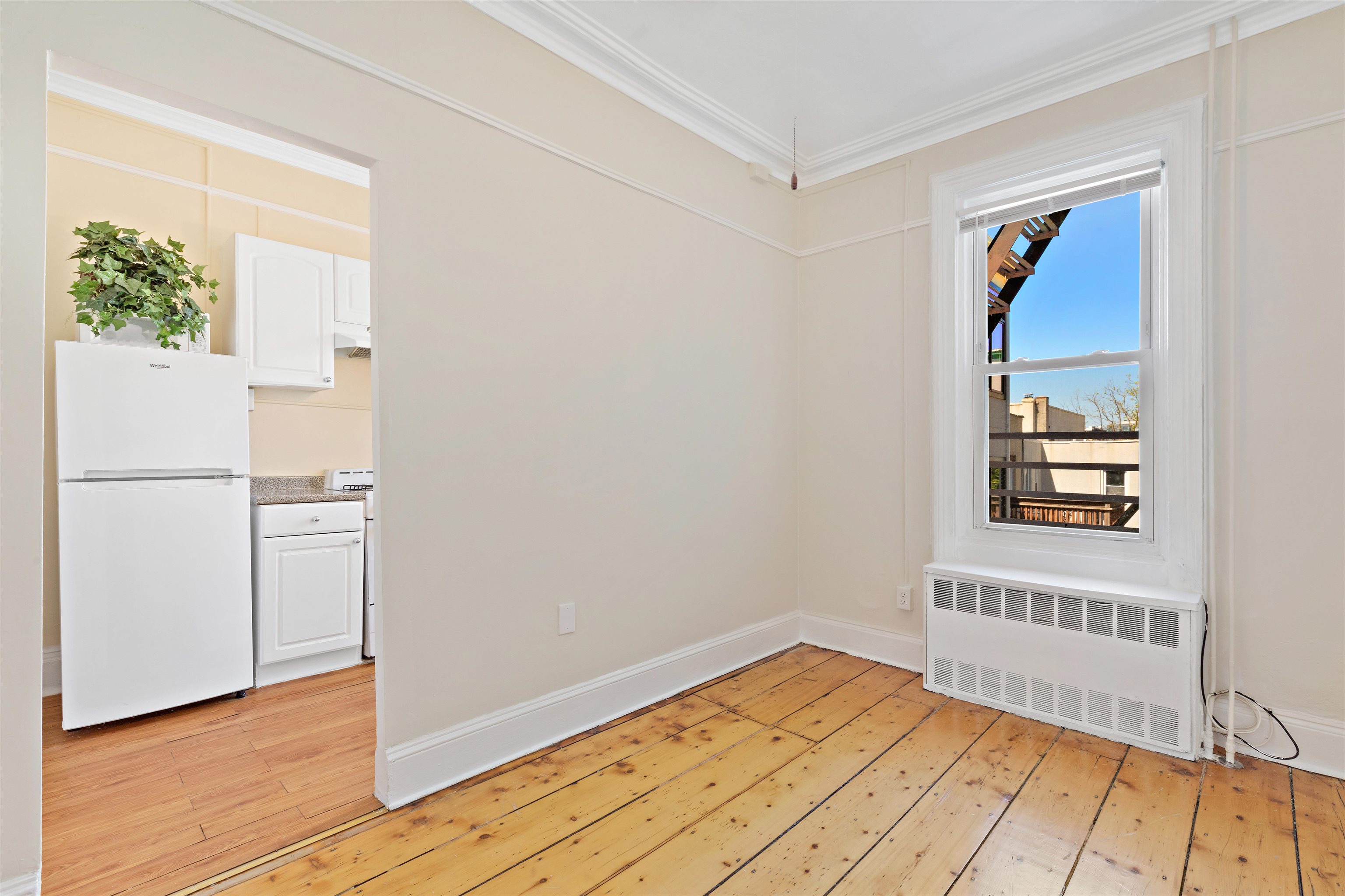 804 Bloomfield Street, Unit 2 Hoboken, NJ 07030 - Photo 6 of 14 a view of a bedroom with wooden floor and a window
