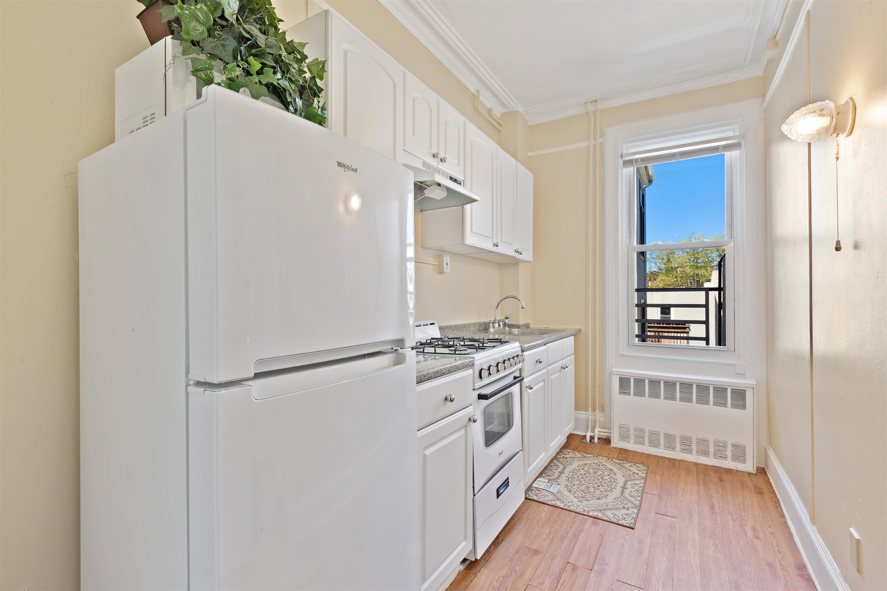 804 Bloomfield Street, Unit 2 Hoboken, NJ 07030 - Photo 8 of 14 a kitchen with white cabinets and white appliances